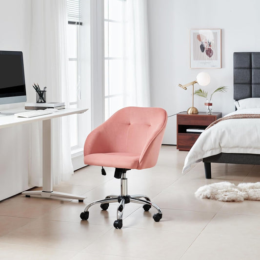 pink upholstered velvet office chair at a bedroom desk and vanity