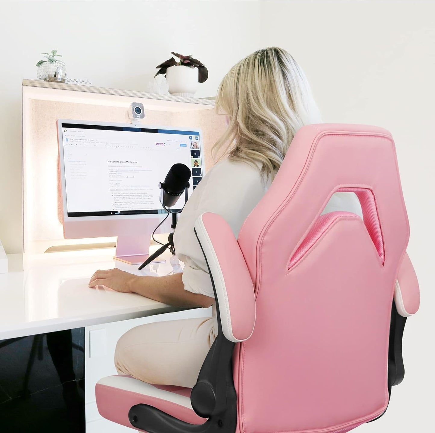 Pink Video Gaming Computer Chair used at a desk in an office with a woman viewing a computer screen